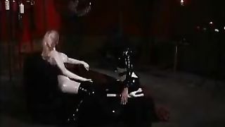 Kinky latex lesbian lovers play with their slave