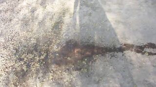 A MILF urinate, during the time that walking behind the garages on the street and in the yard. Urine from underneath her shaved pussy.