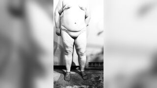 Fat MILF undresses exposed in the basement, showing off her big butt and curvy figure