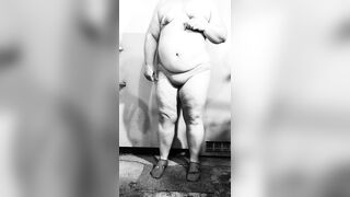 Fat MILF undresses exposed in the basement, showing off her big butt and curvy figure