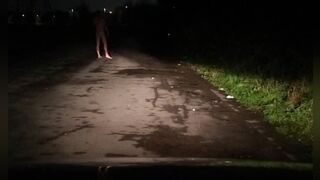 Risky naked on road with car passing