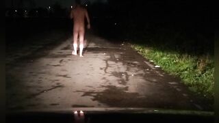 Risky naked on road with car passing