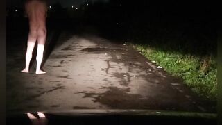 Risky naked on road with car passing