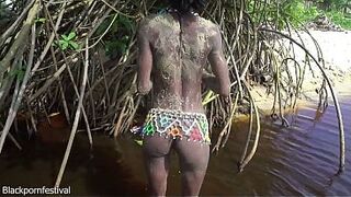 Slim tribe angel with a body full of mud bare outdoor