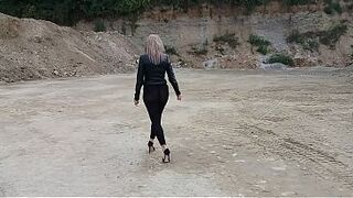 Grandma is walking around a gravel pit in taut leggings and high heels!