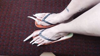 Very long toenails in flipflops