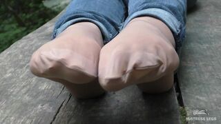 Jeans Feet In Nylon Socks In The Forest