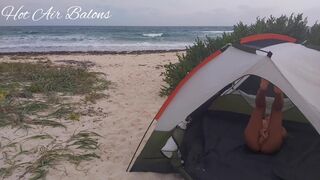 Chick passionately caresses herself on the beach in a tent