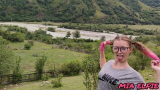 girl with pink tips walks in nature in the mountains attracting attention to herself