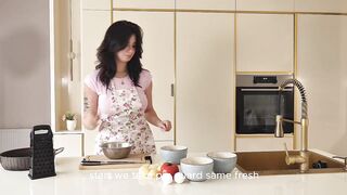 On the film set, the cameraman drilled a feminine makeup artist and a busty food blogger.