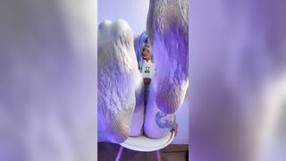 Thick thighs spread wide on the chair