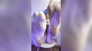 Thick thighs spread wide on the chair