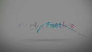 Redhead inked Lauretta likes to play with her feet in nylons