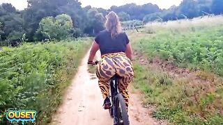 A big-assed woman in constricted leggings rides a bike through the woods and ends up giving head and getting banged outdoors with her massive ass