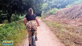 A big-assed woman in constricted leggings rides a bike through the woods and ends up giving head and getting banged outdoors with her massive ass