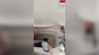 Nice-looking girl gives kitten a bathroom