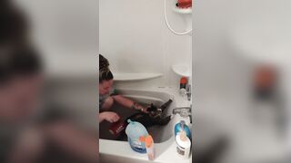 Nice-looking girl gives kitten a bathroom