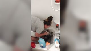 Nice-looking girl gives kitten a bathroom