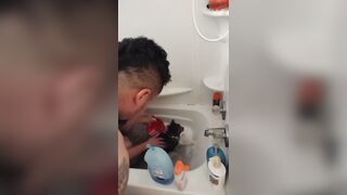 Nice-looking girl gives kitten a bathroom
