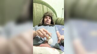 A dude lies down, jerks off, cums, eats cum, and plays with a lighter.