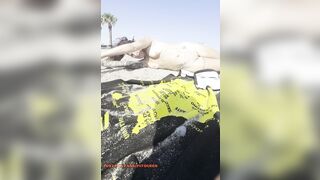 Bare girl playing in the sand?