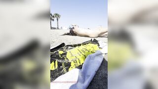 Bare girl playing in the sand?