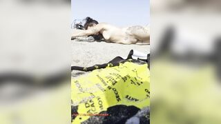 Bare girl playing in the sand?