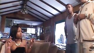 Black slut in hot boots rides a dick while sucking some other on the sofa