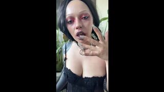Tattooed shoulder peaks as she leans close in black lace