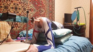 Femboy in an erotic costume Harley Quinn homemade amateur gets her hole drilled by a massive vibrator on a Screw Machine