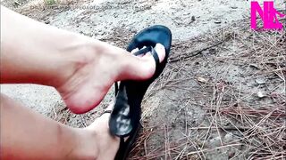 Avid Dangling in My Leather Black Flip Flops in a Park