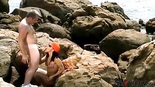A female tourist receives a facial while on rocks.