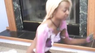 Cute golden-haired ebony angel rubs blue body paint on friends tits
