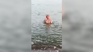 POV. YOU watch as a busty model, unaware of your presence, undresses undressed on the beach, bathes, and plays in the sand.