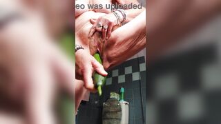 Granny bangs bushy cunt with cucumber