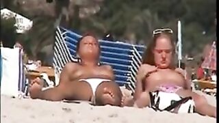 Two topless lesbian girls on the beach
