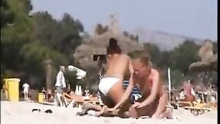 Two topless lesbian girls on the beach