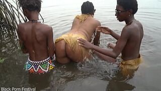 Raw documentary footages with 3 African tribe beauties dancing in the river in the forrest