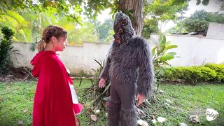 Little Red Riding Hood lost a fruit from her basket and is looking for it in the wolf's pants.