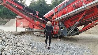 Granny is walking around in a gravel pit wearing sheer leggings!
