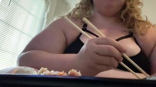 Overweight floozy eats sushi