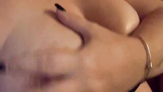 BBW Rubbing lotion on massive tits while staring at camera