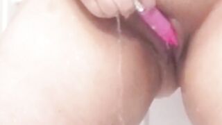 Playing in the shower, legs shaking with pleasure.