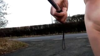 Naked with and without wang pump at side of busy road