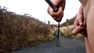 Naked with and without wang pump at side of busy road