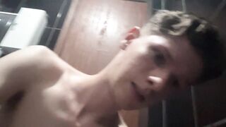Slim twink pumps dick in dim washroom light